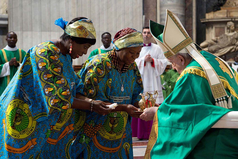 Two members of the Congolese community in Rome present the offertory gifts to Pope Francis during Mass in St. Peter's Basilica at the Vatican July 3. (CNS/Vatican Media)