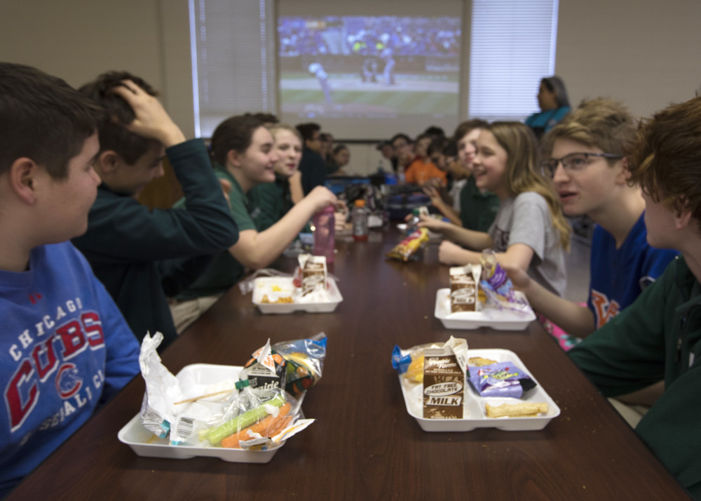 Students at Holy Name of Jesus Catholic School in Henderson, Ky., eat lunch and watch the opening day of Major League Baseball March 29, 2018. (CNS photo/Tyler Orsburn)