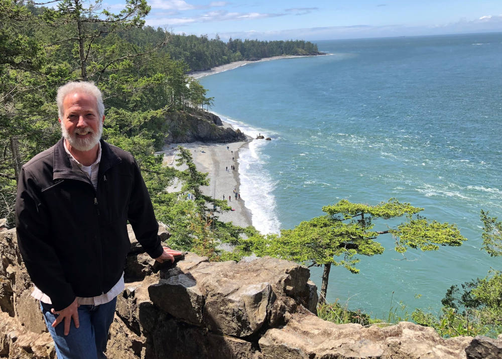 John Mundell poses for a photo against the backdrop of the Puget Sound in the state of Washington. In July, the Vatican Dicastery for Promoting Integral Human Development announced Mundell as director of the Laudato Si' Action Platform. (CNS photo)