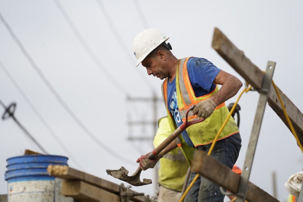 A worker uses a shovel Aug. 30 at a highway construction site in Stony Brook, New York. (CNS/Gregory A. Shemitz)