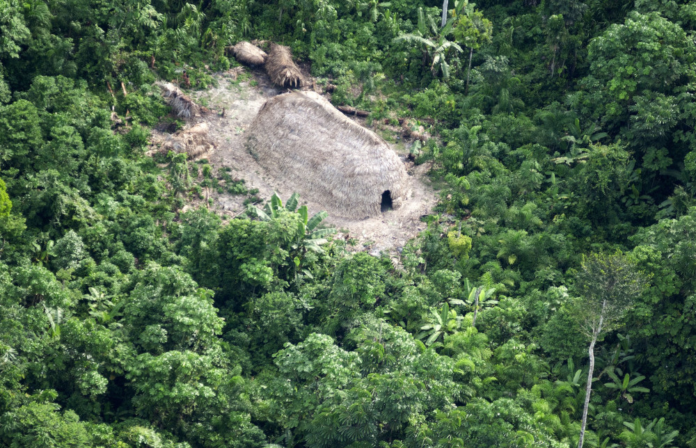 A traditional house called a maloca, built by members of an isolated, semi-nomadic group, is pictured in 2011 near the Jandiatuba River in western Brazil.