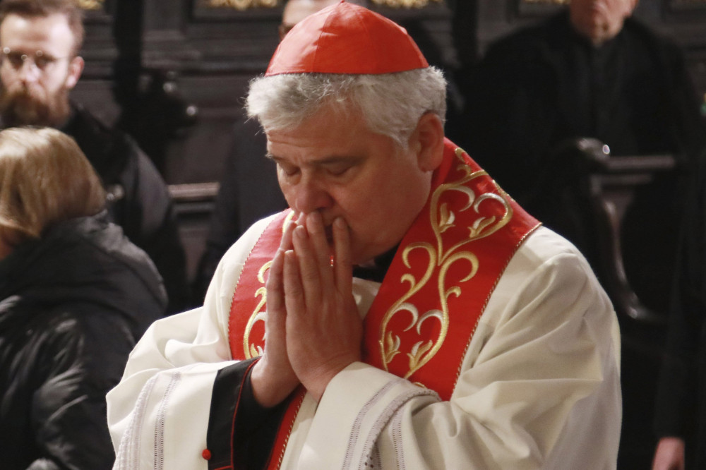 Cardinal Konrad Krajewski, the papal almoner, prays during an interreligious prayer service in the Latin-rite cathedral of Lviv, Ukraine