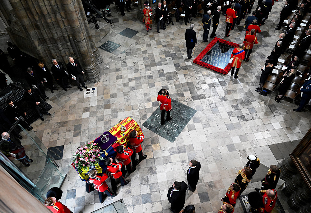 Pallbearers carry the casket of Queen Elizabeth II with the imperial state crown resting on top into Westminster Abbey during her state funeral Sept. 19 in London. (CNS/Gareth Cattermole, pool via Reuters)