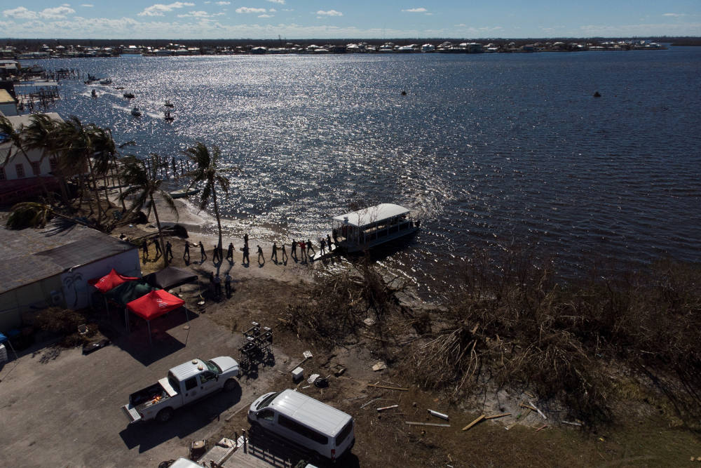 The U.S. Coast Guard in Matlacha, Fla., loads water and other supplies on a boat to be delivered to Pine Island Oct. 2, 2022, after Hurricane Ian caused widespread destruction. (CNS photo/Marco Bello, Reuters)