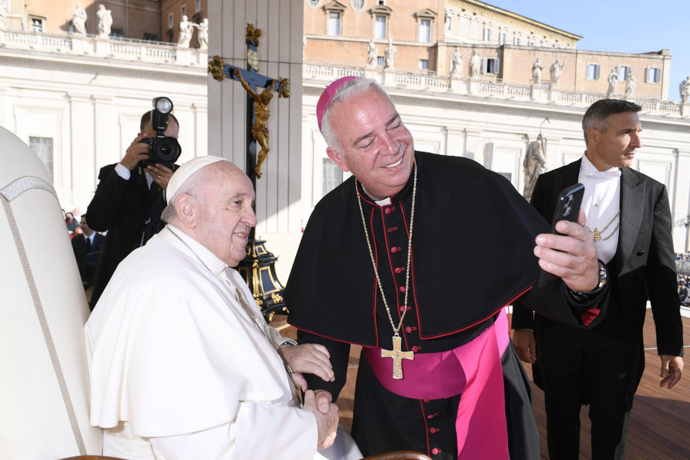 Archbishop Nelson J. Pérez of Philadelphia takes a selfie with Pope Francis at the end of the pope's weekly general audience in St. Peter's Square Oct. 12, 2022