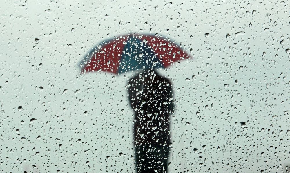 A man in Colombo, Sri Lanka, stands in the rain Dec. 1, 2017. (CNS/Reuters/Dinuka Liyanawatte)