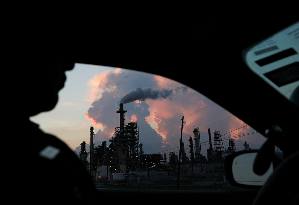 A police officer in in Pasadena, Texas, drives past a refinery Sept. 18, 2018. (CNS/Reuters/Loren Elliott)