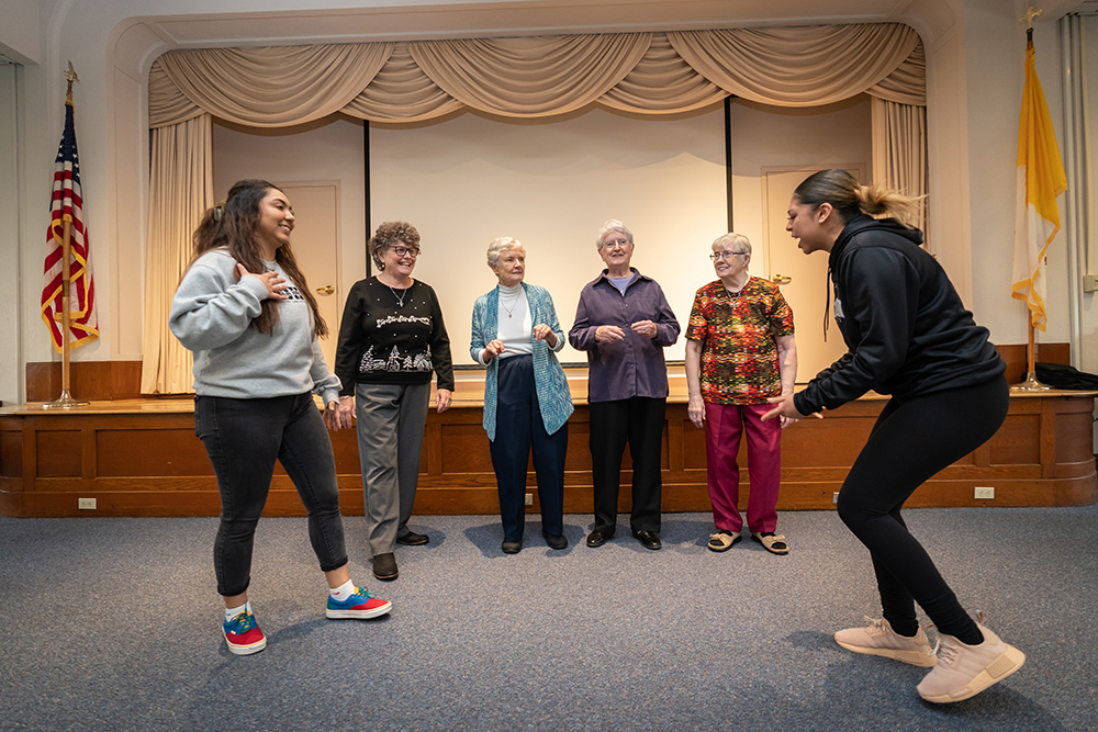 Neumann University students and four Sisters of St. Francis of Philadelphia practice a TikTok video