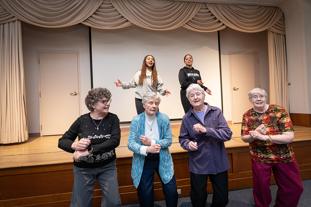 Neumann University students and four Sisters of St. Francis of Philadelphia practice a TikTok video