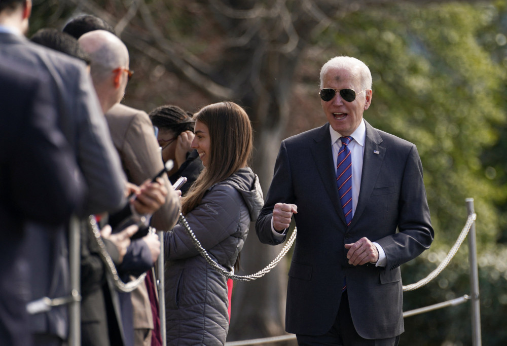 President Joe Biden greets visitors upon his departure from the White House on Ash Wednesday in Washington March 2, 2022. (CNS photo/Kevin Lamarque, Reuters)