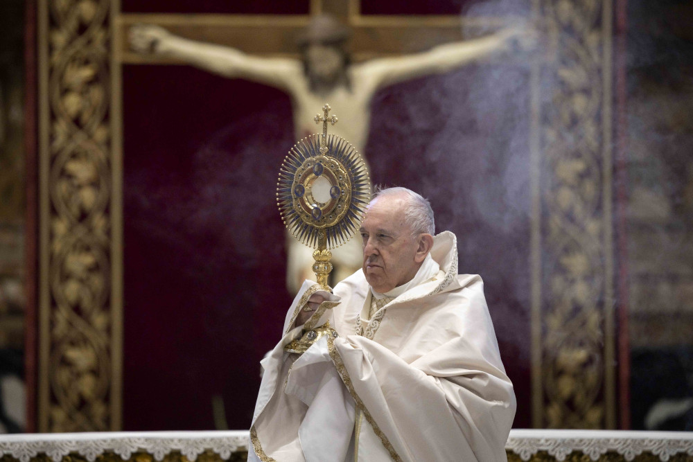 Pope Francis leads Benediction as he celebrates Mass marking the feast of Corpus Christi in St. Peter's Basilica at the Vatican in this June 14, 2020, file photo. (CNS/Vatican Media)