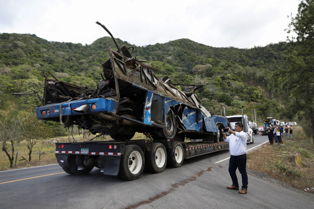 A trailer transports the wreckage of a bus, which was carrying migrants who had traveled through the Darien Gap, in Los Planes de Gualaca, Panama, Feb. 15. (OSV News/Reuters)