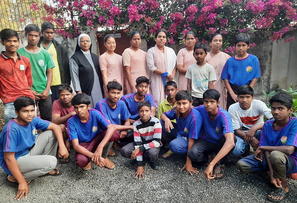 Members of the Daughters of Our Lady of the Garden convent are pictured with boys of Navjeevan, a care home for children rescued from railway platforms in Khandwa, central India. Sr. Ambika Pillai is third from the right in the back row. (GSR photo/Saji Thomas)