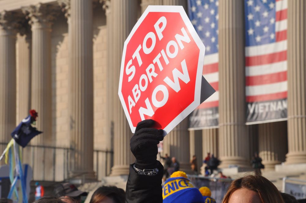 "Stop abortion now" sign at rally