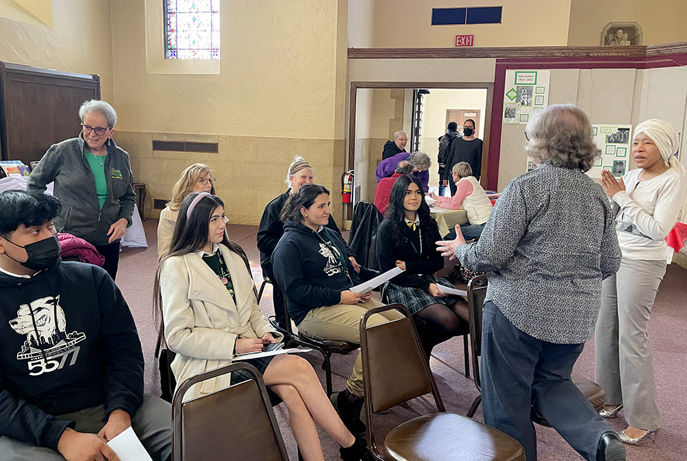 Dominican Sr. Ellen Burkhardt and Laprisha Berry Daniels speak with Detroit Cristo Rey High School students before the March 21 event titled "Detroit's Dirty Air: A Moral Response" began at Gesu Catholic Church. (Amy Ketner)