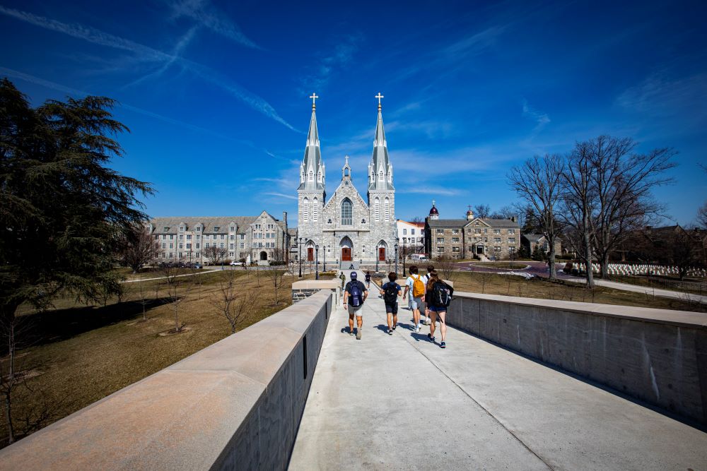 Students walk toward St. Thomas of Villanova Church on the campus of Villanova University near Philadelphia March 11, 2021. 