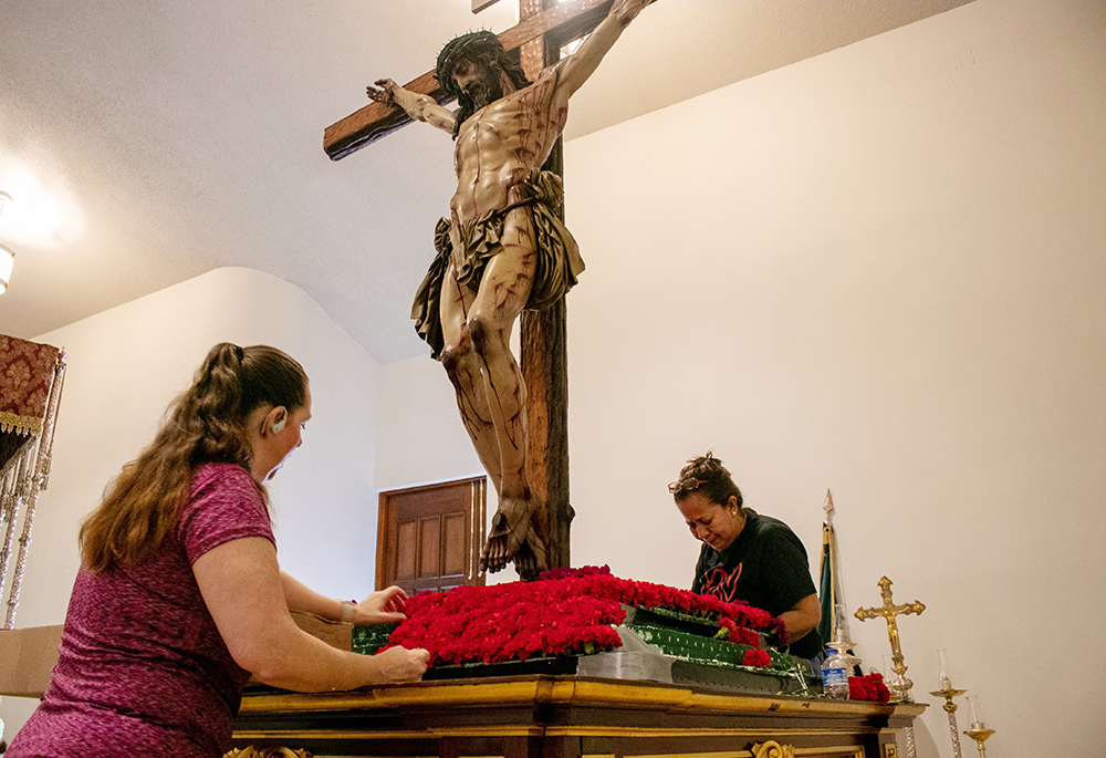 Parishioners at Corpus Christi Parish in Miami decorate the platform of the Christ of Mercy (Cristo de la Misericordia) for the Good Friday procession April 15, 2022. The cedar wood sculpture made by Juan Manuel Miñarro, who studied the Shroud of Turin and the Sudarium of Oviedo, depicts Jesus Christ crucified. (OSV News/Florida Catholic/La Voz Católica/Rocío Granados)