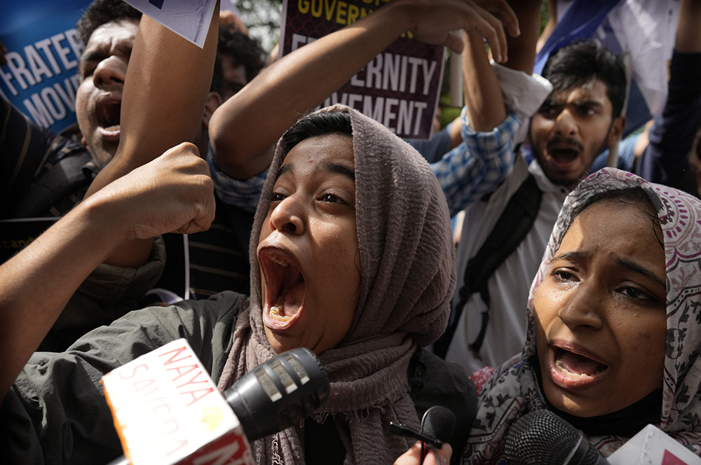 Muslim students shout anti-government slogans during a protest outside Uttar Pradesh house, in New Delhi, June 13, 2022. The students were protesting against persecution of Muslims and recent demolition of their houses after protests against former Bharatiya Janata Party spokesperson Nupur Sharma’s remark deemed derogatory to Islam’s Prophet Muhammad. (RNS/AP/Manish Swarup)