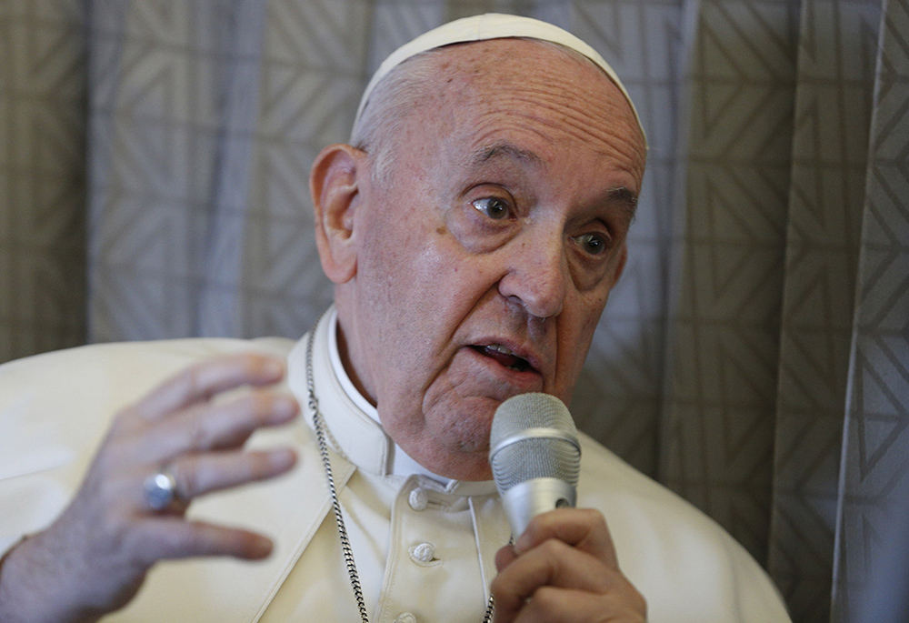 Pope Francis answers questions from journalists aboard his flight Sept. 15, 2022, from Nur-Sultan, Kazakhstan, to Rome. Francis said to reporters: "To defend oneself is not only licit, it is also an expression of love toward one's homeland." (CNS/Paul Haring)