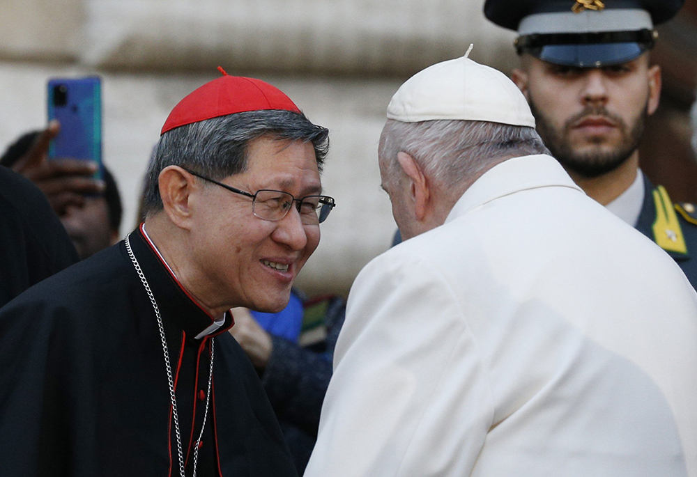 Pope Francis talks with Cardinal Luis Antonio Tagle after praying in front of a Marian statue at the Spanish Steps in Rome Dec. 8, 2022, the feast of the Immaculate Conception. (CNS/Paul Haring)