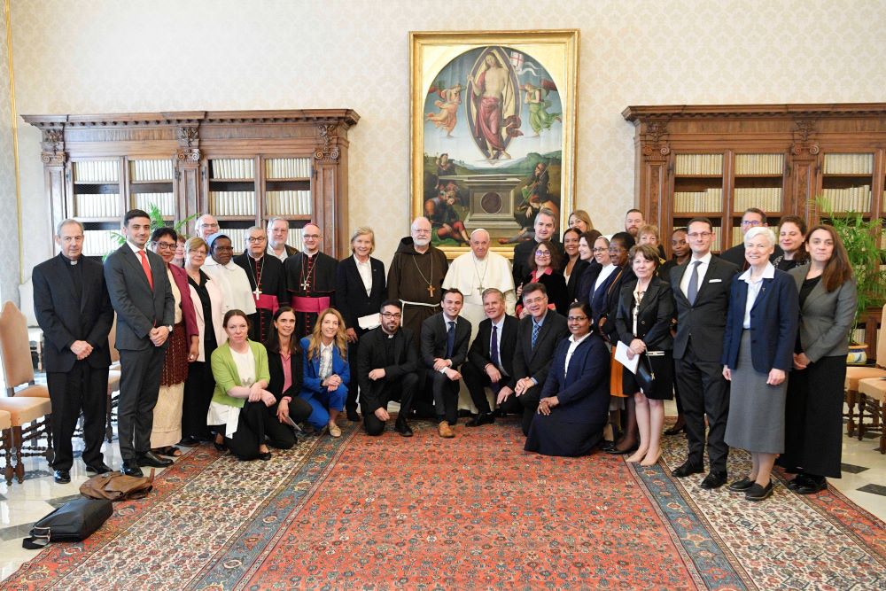 Pope Francis poses for a photograph with staff and members of the Pontifical Commission for the Protection of Minors and its leadership.