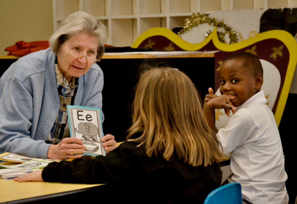 Mercy Sr. Joan Serda works with kindergartners Ella, left, and Jaden on March 16 at St. Pius X Catholic School in Mobile, Alabama. (GSR photo/Dan Stockman)