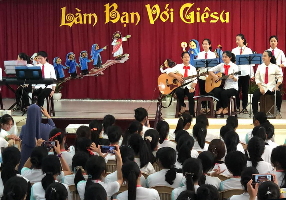 Lovers of the Holy Cross of Hue sisters play various musical instruments to welcome female students aged 13-15 to the World Day of Prayer for Vocations celebrations at their motherhouse in Hue, Vietnam, April 28. The gathering was themed "Making Friends With Jesus." The sisters also shared their experiences in religious vocation with participants. (Joachim Pham)