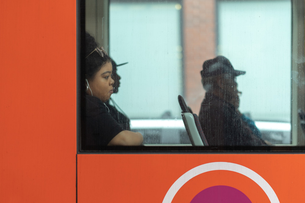 People riding on a bus (Unsplash/Mark Cook)