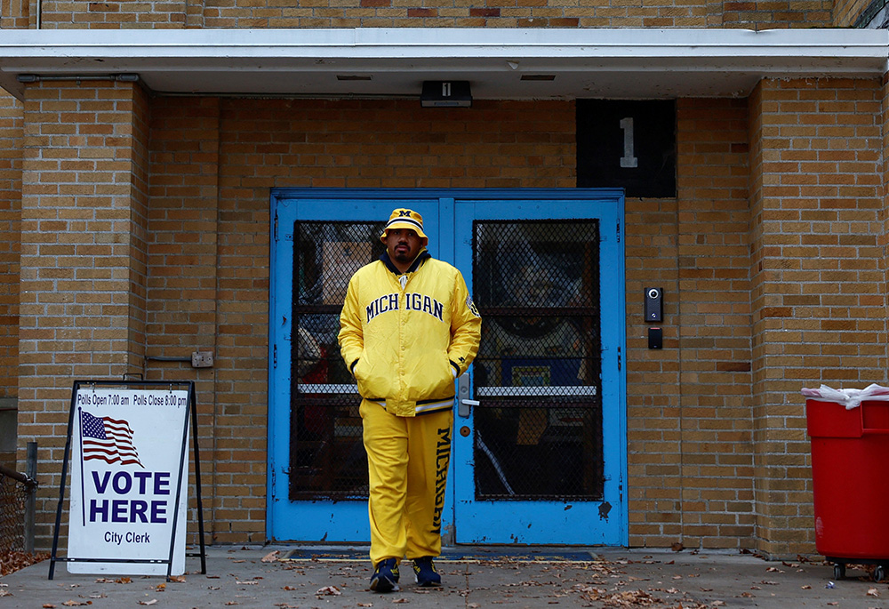 A Michigan voter leaves Louis Pasteur Elementary School on midterm election day Nov. 8, 2022 in Detroit. Ronald Reagan accepted the presidential nomination of his party in that city’s Cobo Hall in 1980. His shadow still lingers over the city’s decline, says Michael Sean Winters. (CNS/Reuters/Evelyn Hockstein)