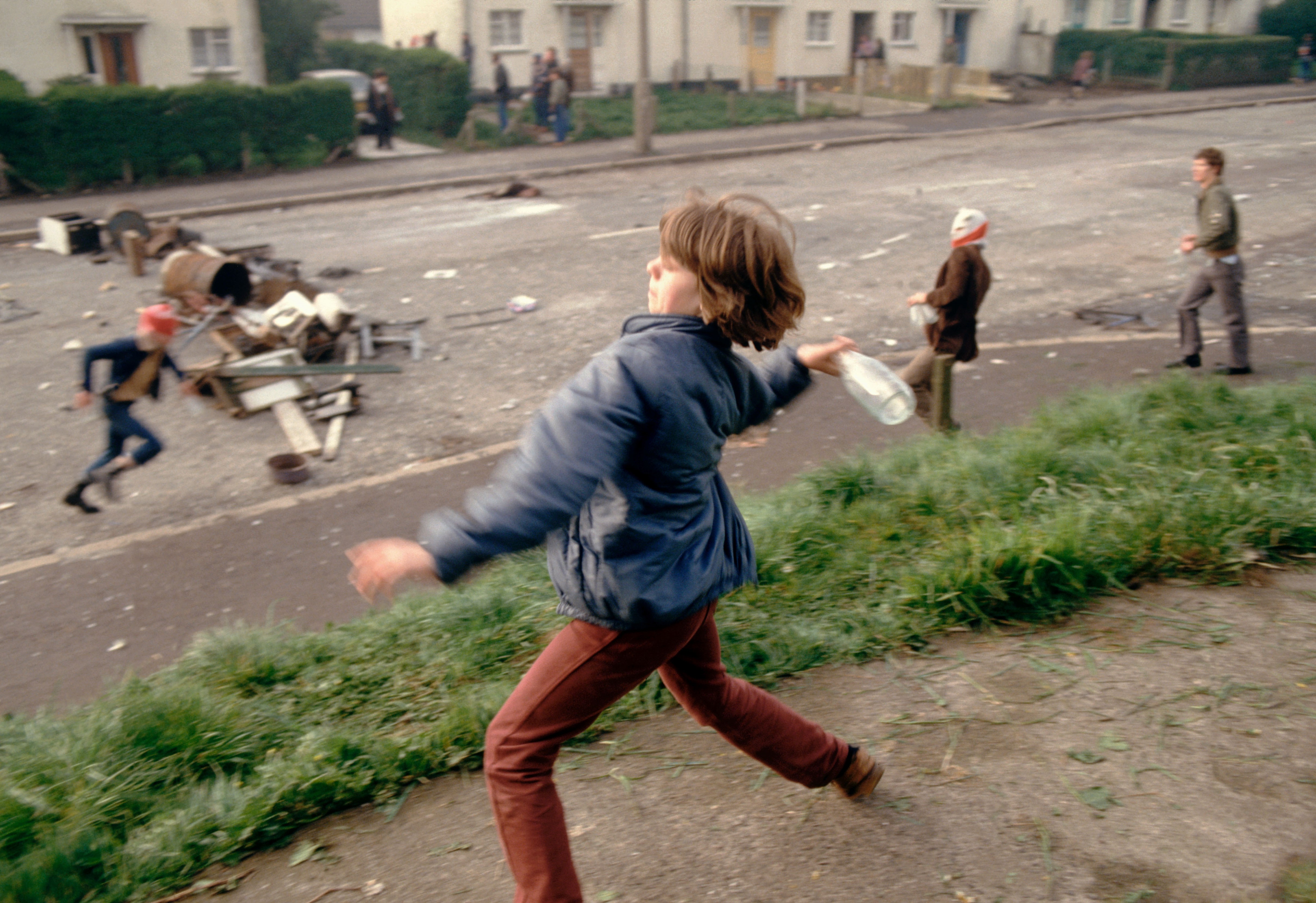 In this image from the PBS documentary series "Once Upon a Time in Northern Ireland," Anne Marie, 10, throws bottles at British troops during a riot in Belfast, Northern Ireland, in 1981. (PBS/Courtesy of Magnum Photos/Peter Marlow)