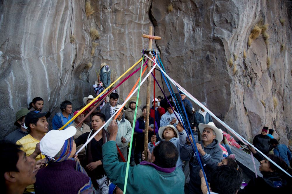 People who live in nearby villages hold ceremony on a rock formation on the slopes of the Popocatepetl volcano in Mexico, March 12, 2014. Every March 12, people from the villages surrounding the Popocatepetl volcano trek up its slopes to make offerings and play music in asking the mountain to spare them from eruptions. 