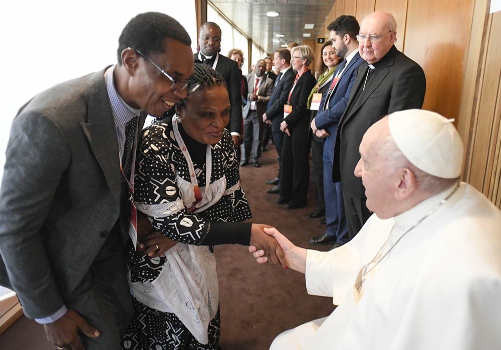 Pope Francis greets participants after speaking at a Vatican conference, "Pastors and lay faithful called to walk together," Feb. 18, in the Vatican synod hall. The meeting was sponsored by the Dicastery for Laity, the Family and Life. This October's meeting on the future of the church will take place in the larger Pope Paul VI audience hall. (CNS/Vatican Media)