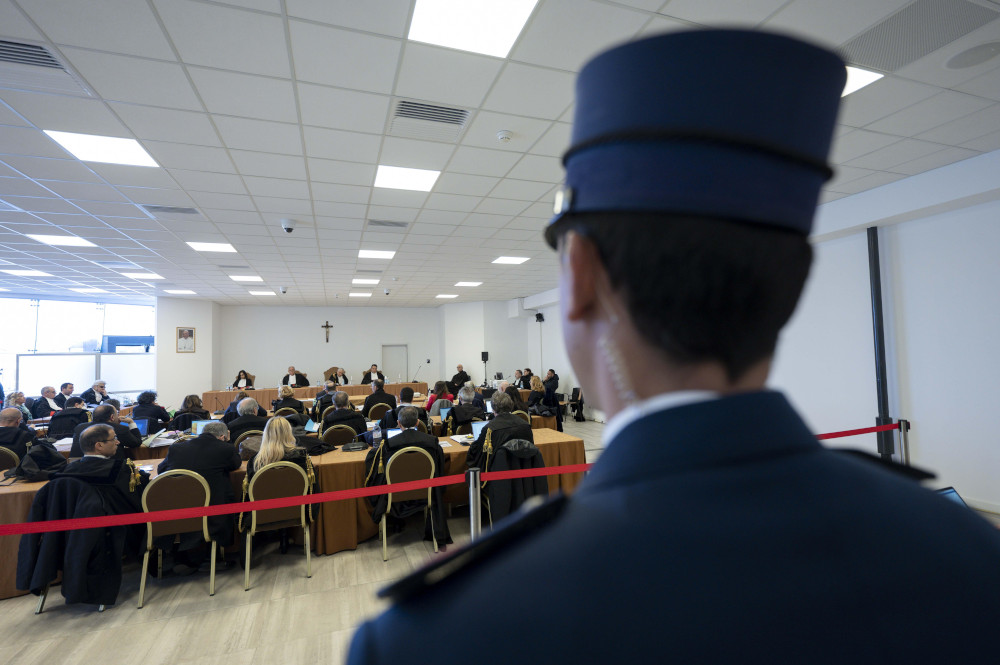 A Vatican police officer keeps watch March 16, 2023, during the trial of Cardinal Angelo Becciu and nine other defendants on charges of financial malfeasance. The trial is being held in a makeshift courtroom at the Vatican Museums. (CNS photo/Vatican Media)