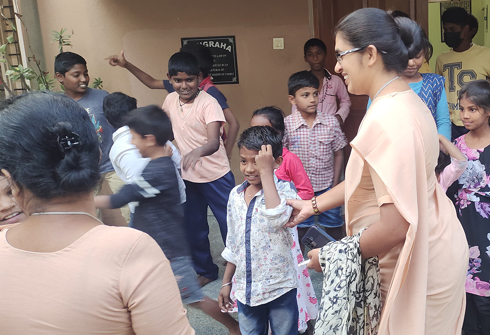 St. Joseph of Tarbes Sister Mariamma (with spectacles) and Sr. Irudaya Mary (back to the camera) prepare children from slums for tuition classes at Sangraha, a shelter home her congregation manages for destitute women and children in the southern Indian city of Bengaluru. (Thomas Scaria)