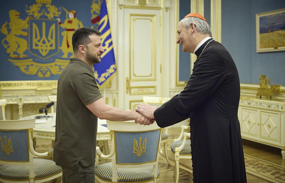 Ukrainian President Volodymyr Zelenskyy, left, shakes hands with Cardinal Matteo Zuppi in Kyiv, Ukraine, June 6, during the first leg of the cardinal's peace mission. (Ukrainian Presidential Press Office via AP)