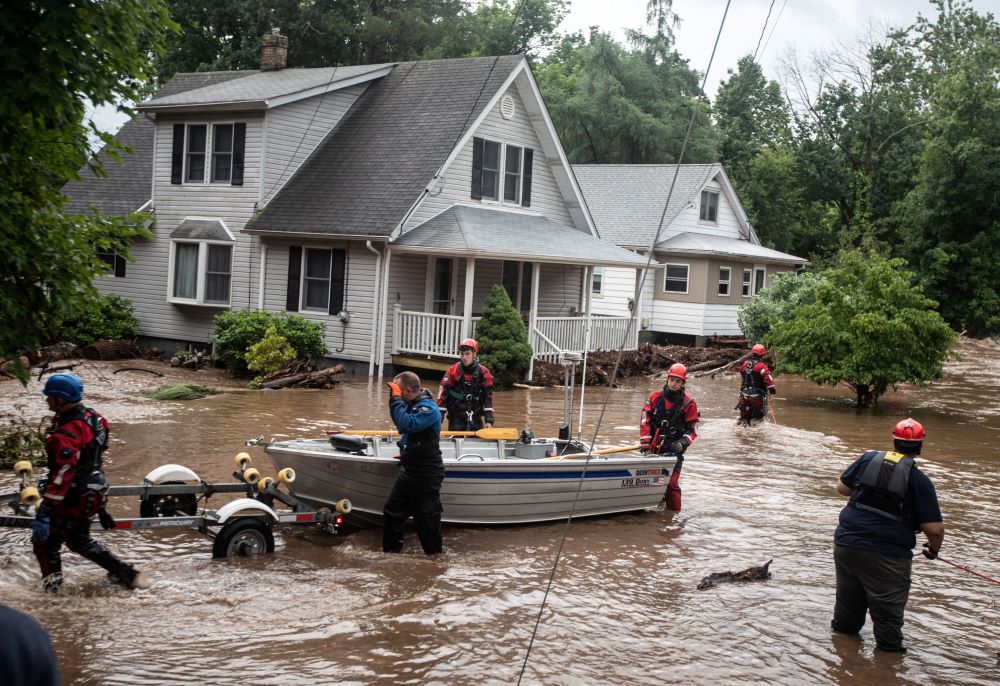 Emergency personnel maneuver a boat used to rescue residents of flooded homes in Stony Point, N.Y., July 9, 2023. Severe storms that left at least one dead in Orange County, dumped heavy rainfall at intense rates over parts of the Northeast, forcing road closures, water rescues and urgent warnings about life-threatening flash floods. (OSV News/Reuters/USA Today Network/Seth Harrison)