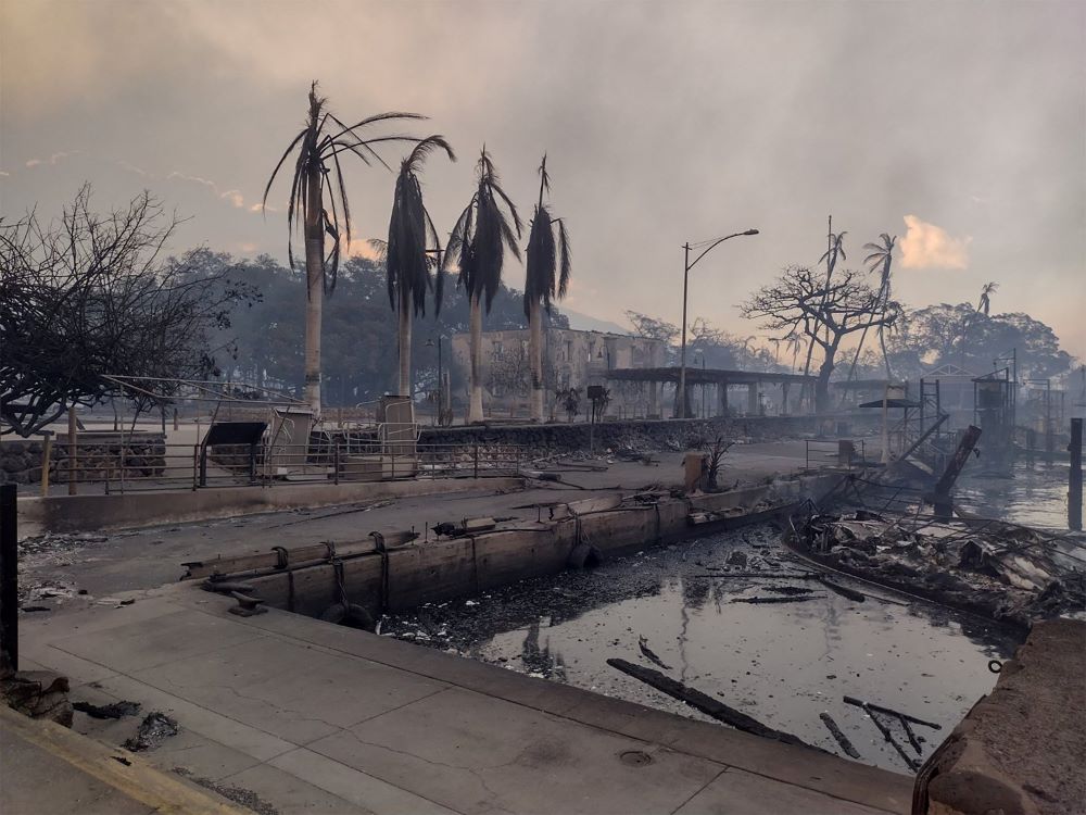 A charred boat lies in the scorched waterfront Aug. 9, 2023, after wildfires fanned by the winds of a distant hurricane devastated Lahaina, Hawaii, on the island of Maui. (OSV News/Reuters/Mason Jarvi)