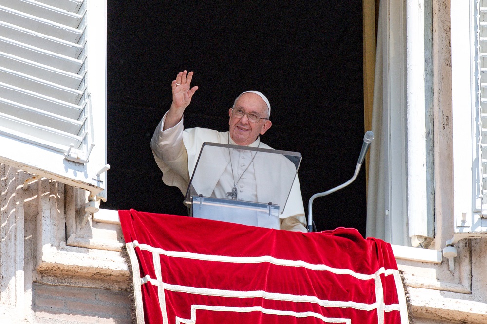 Pope Francis greets visitors in St. Peter's Square at the Vatican to pray the Angelus Aug. 20, 2023.