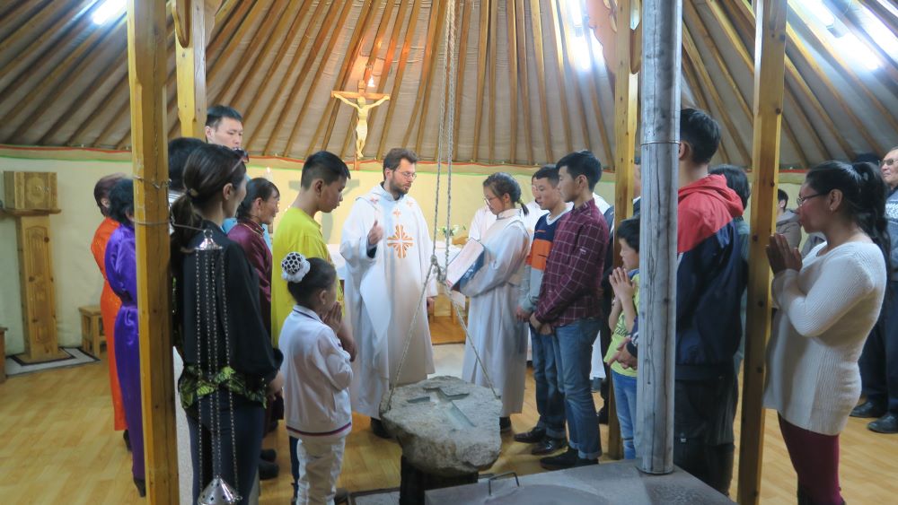 Cardinal Giorgio Marengo, apostolic prefect of Ulaanbaatar, Mongolia, center, is pictured celebrating Mass in a March 31, 2018, file photo. Mongolia's Catholic community is one of the world's smallest. (CNS/Courtesy AfMC Torino)