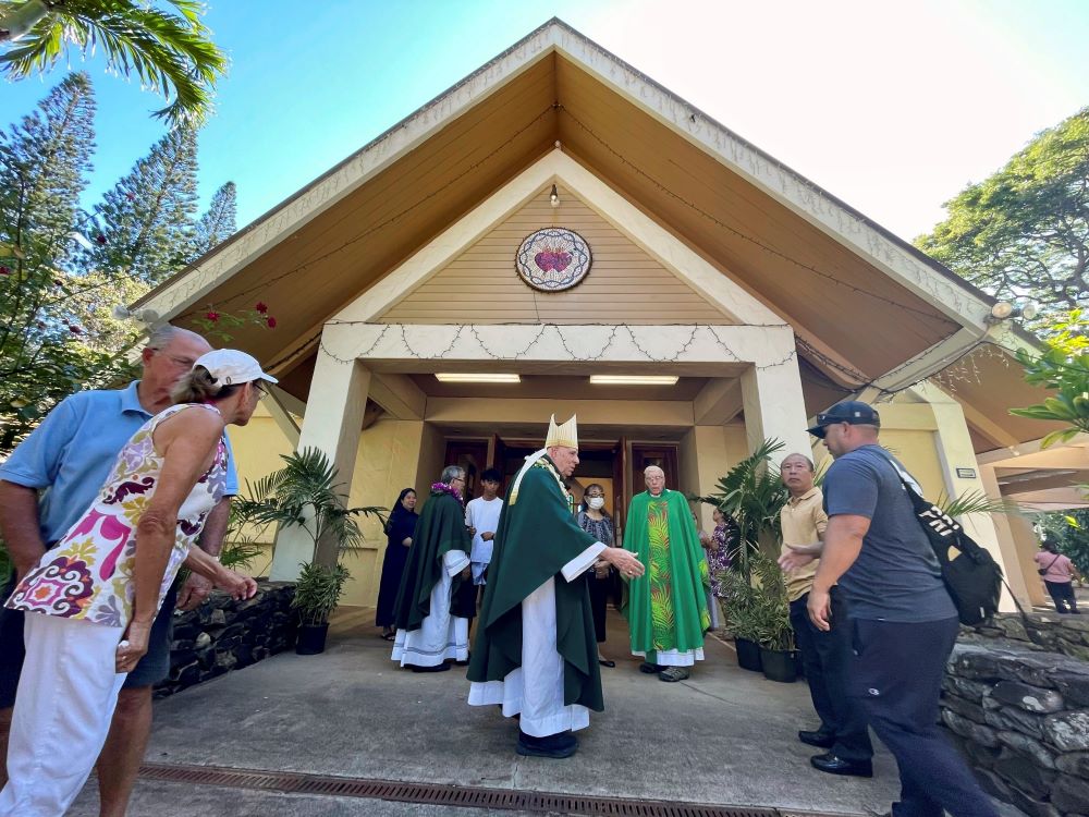 Most Rev. Clarence "Larry" Silva, the Bishop of Honolulu, greets parishioners after Mass at Sacred Hearts Mission Church in Kapalua, Hawaii, Sunday, Aug. 13, 2023.