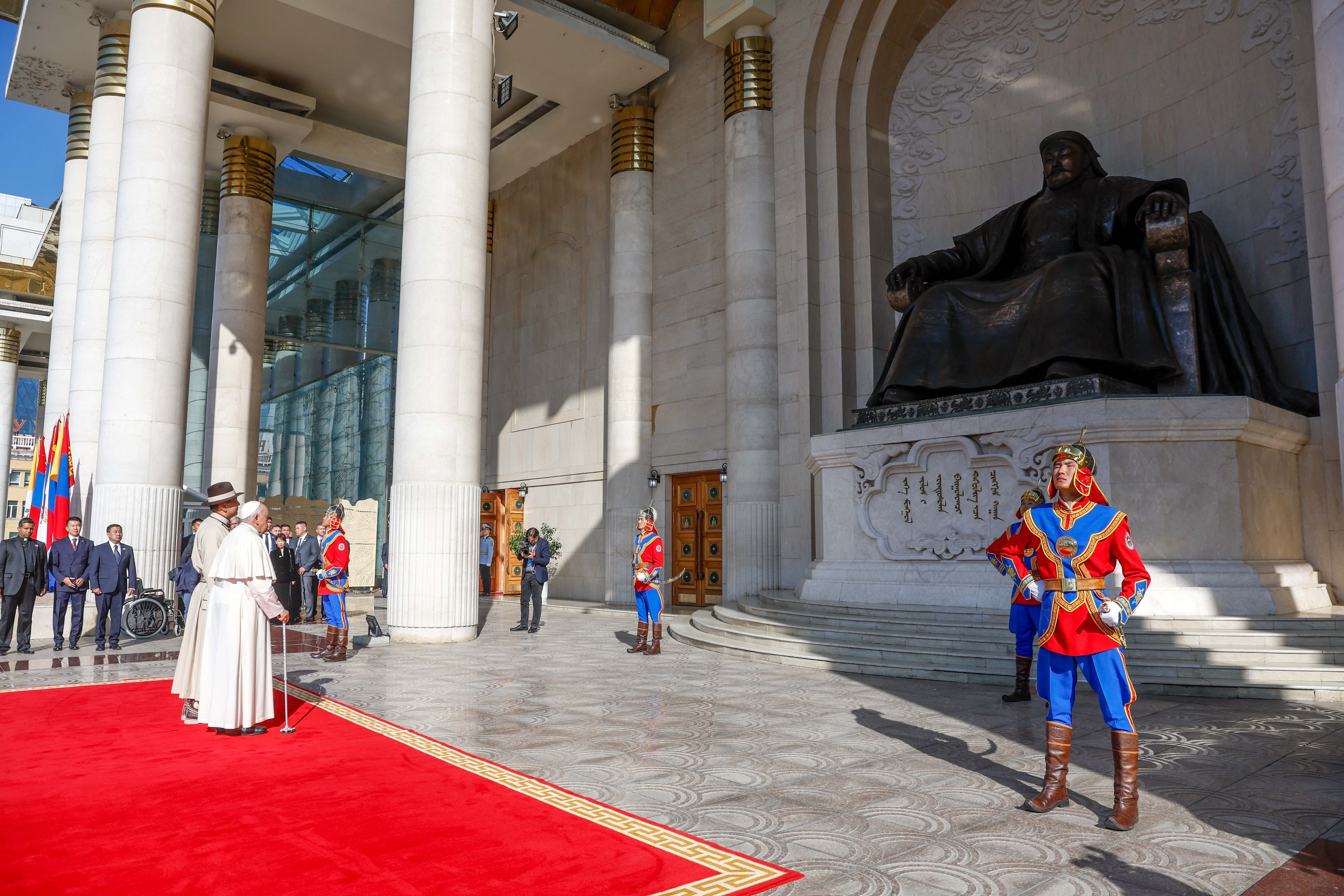 Pope Francis stands next to Mongolian President Ukhnaagiin Khürelsükh in front of a statue of Genghis Khan during an official welcome ceremony in Sükhbaatar Square in Ulaanbaatar, Mongolia, Sept. 2, 2023. (CNS photo/Lola Gomez)