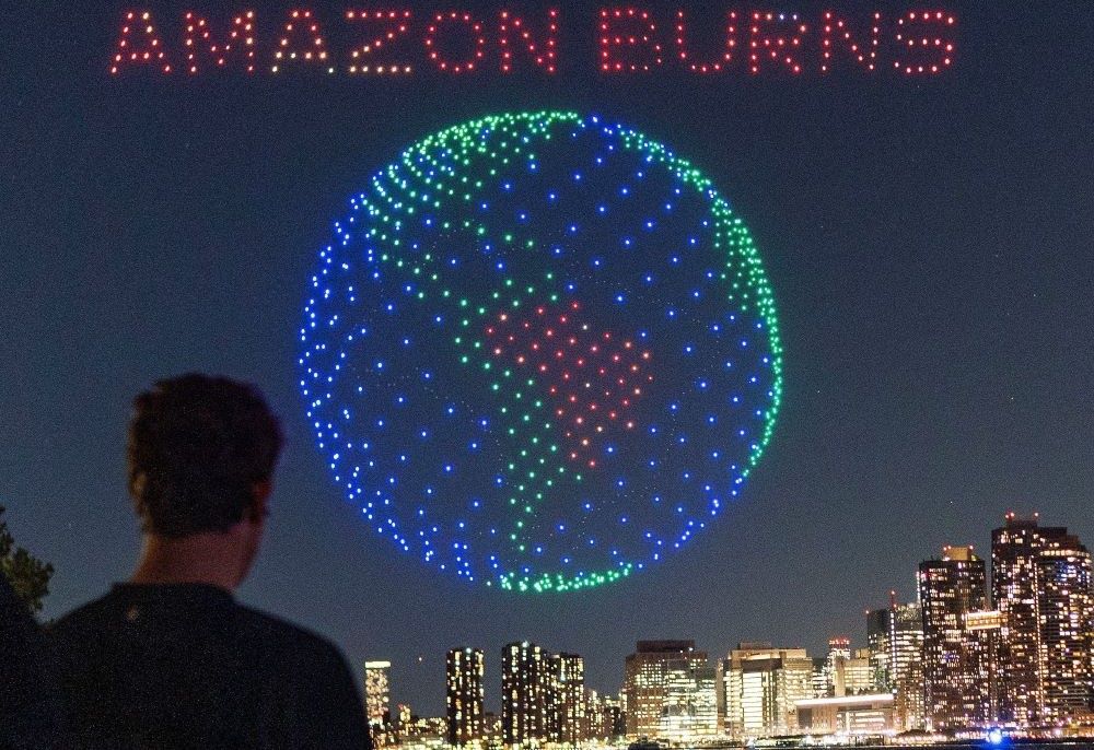 People watch drones creating a 3D display outside the United Nations Headquarters calling attention to the Amazon rainforest and climate change in New York City Sept. 15. (OSV News/Reuters/Eduardo Munoz)