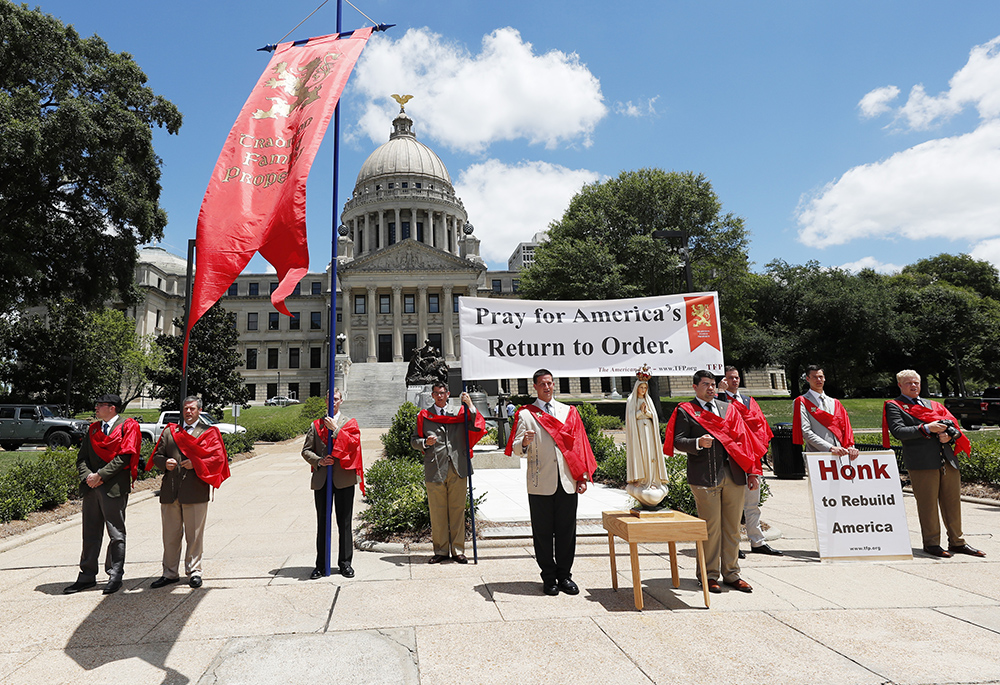 Members of the American Society for the Defense of Tradition, Family and Property, an organization of lay Catholic Americans, pray the rosary in front of the Mississippi Capitol June 11, 2020, in Jackson, Mississippi. According to The Associated Press, the organization had teams of volunteers visiting each state capitol, offering prayers and reciting the rosary on the state grounds for the country and the moral crisis they believe faces the Christian civilization. (AP photo/Rogelio V. Solis)