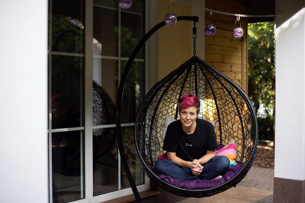 Dominika Gala sits in a birdcage chair