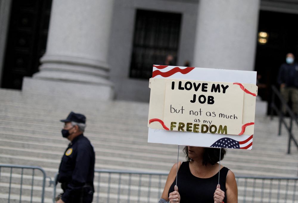 A woman in New York City holds a sign Oct. 12, 2021, during a protest over the city's COVID-19 vaccine mandate.