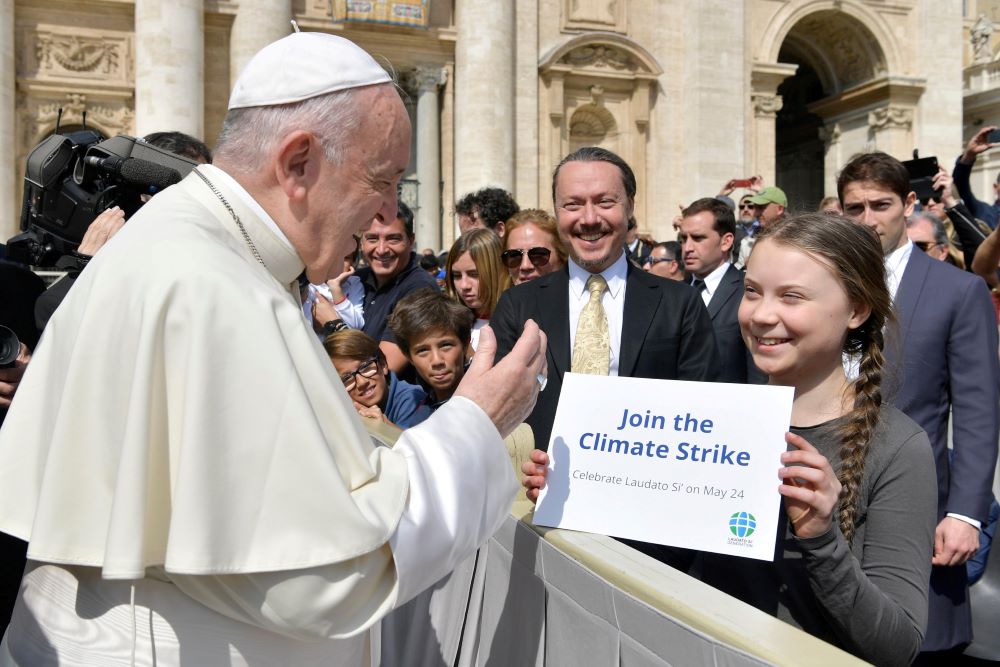 Pope Francis greets Swedish climate activist Greta Thunberg during his general audience in St. Peter's Square at the Vatican in this file photo from April 17, 2019.