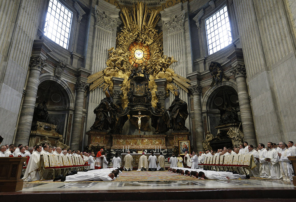 New deacons from the Pontifical North American College lie prostrate during their ordination in St. Peter's Basilica Sept. 29, 2022, at the Vatican. In Episode 3 of "The Vatican Briefing," Bishop Shane Mackinlay, a member of the synod's Commission for the Synthesis Report, expresses openness to ordaining women as Catholic deacons. (CNS photo/Paul Haring)