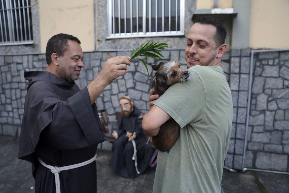 A priest blesses a dog outside a church during a prayer service for blessing of the animals in Rio de Janeiro Oct. 4, 2023, the feast of St. Francis of Assisi, patron of animals. (OSV News photo/Pilar Olivares, Reuters)