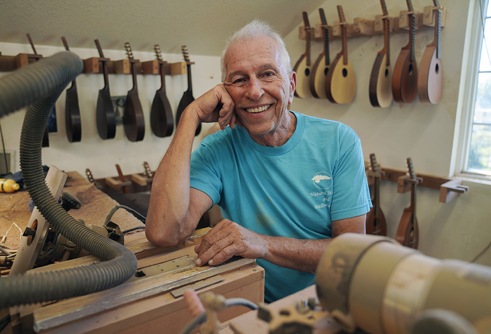 Mike Dulak sits for a portrait in his mandolin workshop in Rocheport, Missouri, Sept. 8. Dulak does not associate with any religious group and self-identifies as "nothing in particular" when asked about his beliefs. (AP/Jessie Wardarski)