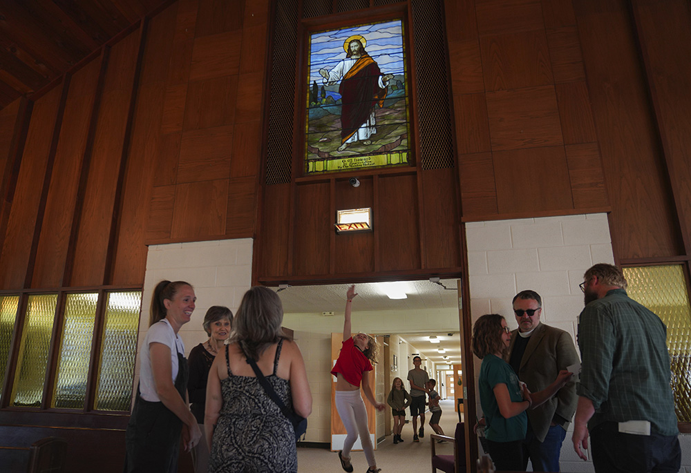 A young girl jumps to touch the doorway to the sanctuary of First Baptist Church in Mount Vernon, Illinois, on Sunday, Sept. 10. (AP/Jessie Wardarski)